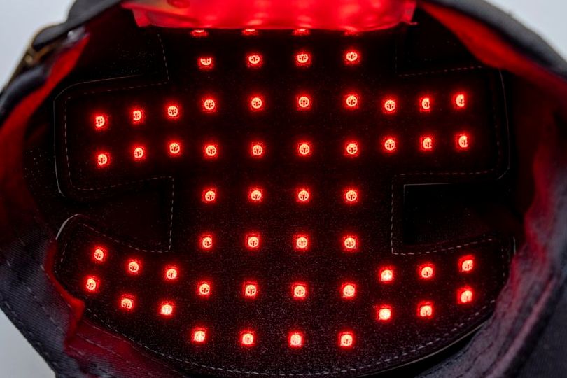 Interior of a red light therapy laser cap with LEDs illuminated